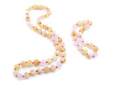 Certified raw butterscotch amber teething necklace paired with a matching anklet featuring matte pink quartz 