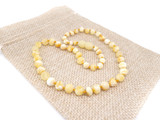 Unpolished milky white Baltic amber teething necklace in butterscotch tones with handcrafted baroque beads