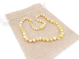 Rare butterscotch white Baltic amber teething necklace featuring unpolished baroque stones