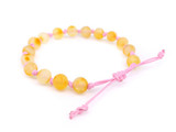 Baltic amber teething bracelet with pink adjustable cord handcrafted in the Baltic Sea region 