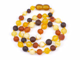 Natural raw Baltic amber teething necklace featuring a mix of multicoloured rounded beads for infants and toddlers