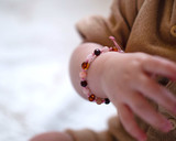 Pink adjustable amber teething bracelet or anklet for babies and toddlers