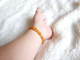 Handcrafted raw honey amber stretch teething anklet made in the Baltic region 