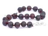 Hand-knotted dark cherry amber teething anklet, handcrafted in the Baltic region 