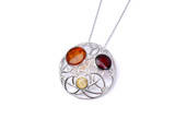 Detailed view of a natural Baltic amber silver pendant showing polished gemstone surfaces, translucent amber colours and delicate intertwined metalwork