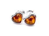 Natural cognac Baltic amber heart stud earrings in hallmarked 925 sterling silver, featuring polished heart-shaped amber stones with warm golden-orange tones