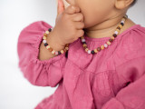 Children’s Baltic amber teething set combining mixed raw amber tones with matte pink quartz beads