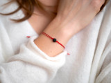 Red string bracelet with dark cherry raw amber