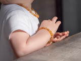 Honey-coloured Baltic amber teething bracelet with smooth raw beads handcrafted for kids in traditional Baltic style 