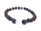 Natural Baltic amber bracelet for teething crafted from raw dark cherry beads and an Evil Eye charm handmade in the Baltic region 