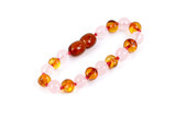 Soothing baby anklet and bracelet with Baltic amber and pink rose quartz, perfect for newborn wellness