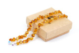 Amber teething necklace with colourful flower-shaped decorative beads