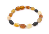 Close-Up of Raw Baltic Amber Olive-Shaped Beads in Natural Multicolour Shades