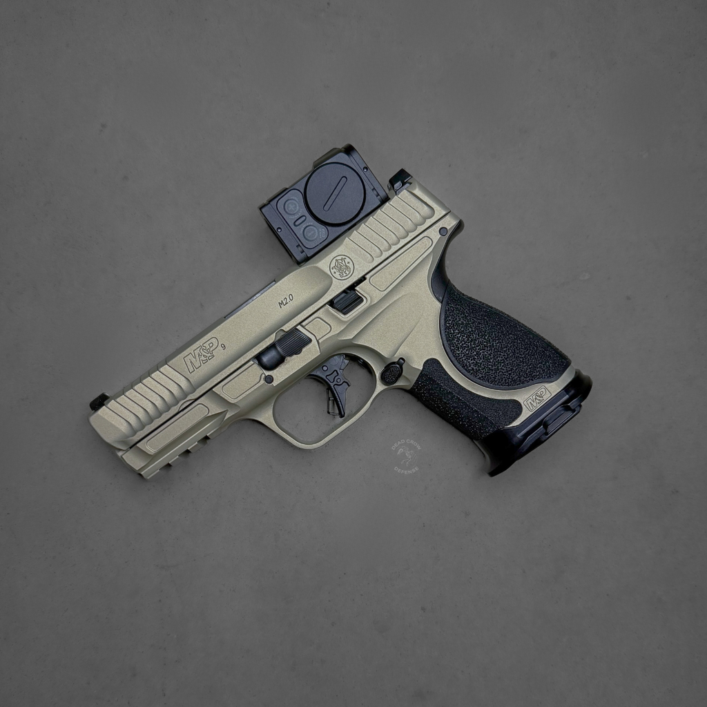 Smith & Wesson, M&P M2.0 Metal Compact, Spec Series VI, Semi-automatic, Striker Fired, Aluminum Frame Pistol, Compact, 9MM, 4" Barrel, Cerakote Finish, Champagne, Aimpoint ACRO P-2 Optic, Inline Ported Slide, Floyds Custom Shop EDC Magwell and Baseplates, Adjustable Sights, 15 Rounds, 3 Magazines, Includes Savior Pistol Bag, Hunter Constantine Carry Belt, Spec Series VI Knife & Spec Series Patch, 14634
UPC: 022188905021, Smith & Wesson M&P M2.0 Metal Compact Spec Series VI with Aimpoint ACRO P-2 optic
Ported slide M&P M2.0 Metal Compact Spec Series VI performance pistol
Floyd’s Custom Shop magwell on Smith & Wesson M&P M2.0 Spec Series VI
Smith & Wesson M&P M2.0 Metal Compact Spec Series VI bundle with ACRO optic and accessories