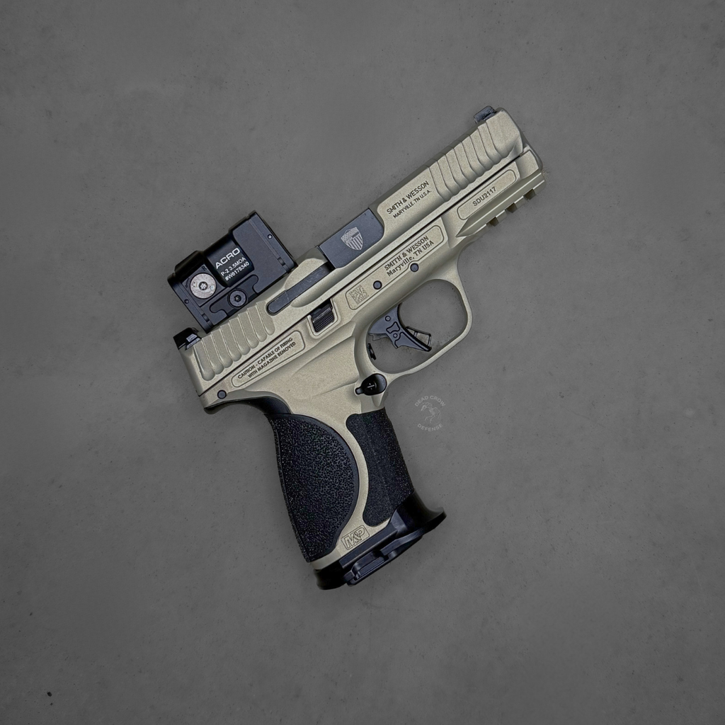 Smith & Wesson, M&P M2.0 Metal Compact, Spec Series VI, Semi-automatic, Striker Fired, Aluminum Frame Pistol, Compact, 9MM, 4" Barrel, Cerakote Finish, Champagne, Aimpoint ACRO P-2 Optic, Inline Ported Slide, Floyds Custom Shop EDC Magwell and Baseplates, Adjustable Sights, 15 Rounds, 3 Magazines, Includes Savior Pistol Bag, Hunter Constantine Carry Belt, Spec Series VI Knife & Spec Series Patch, 14634
UPC: 022188905021, Smith & Wesson M&P M2.0 Metal Compact Spec Series VI with Aimpoint ACRO P-2 optic
Ported slide M&P M2.0 Metal Compact Spec Series VI performance pistol
Floyd’s Custom Shop magwell on Smith & Wesson M&P M2.0 Spec Series VI
Smith & Wesson M&P M2.0 Metal Compact Spec Series VI bundle with ACRO optic and accessories