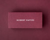 Custom burgundy flat place card featuring the name Robert Davies in white serif font, ideal for elegant table settings and luxury event stationery.