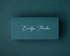 A personalised Hunter Green flat place card printed in white ink in elegant calligraphy.