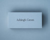 A personalised Dusty Blue place card printed with black ink in a modern calligraphy font.