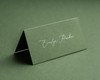 Olive green folded place card with delicate white ink personalised name printing.