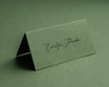 Olive green folded place card with elegant black ink personalised name printing.