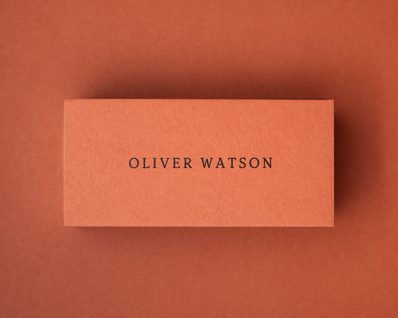 Burnt Orange place card with sample name "Oliver Watson" printed in black ink, showing personalised stationery for rustic weddings and seasonal gatherings.
