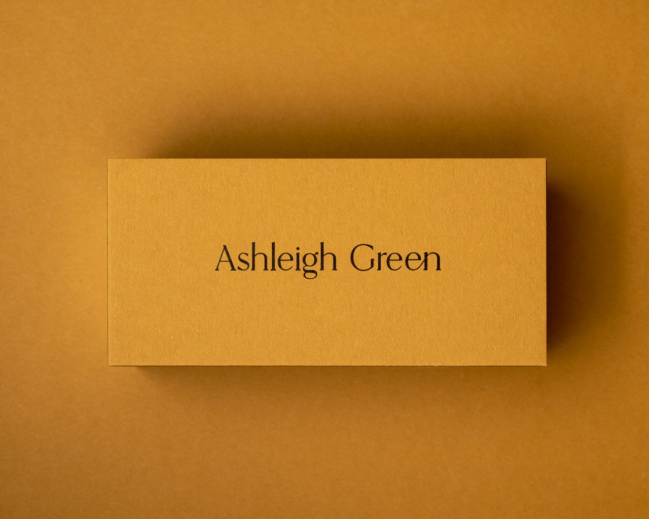 Mustard place card printed in black ink, showcasing custom name cards for modern wedding table décor.