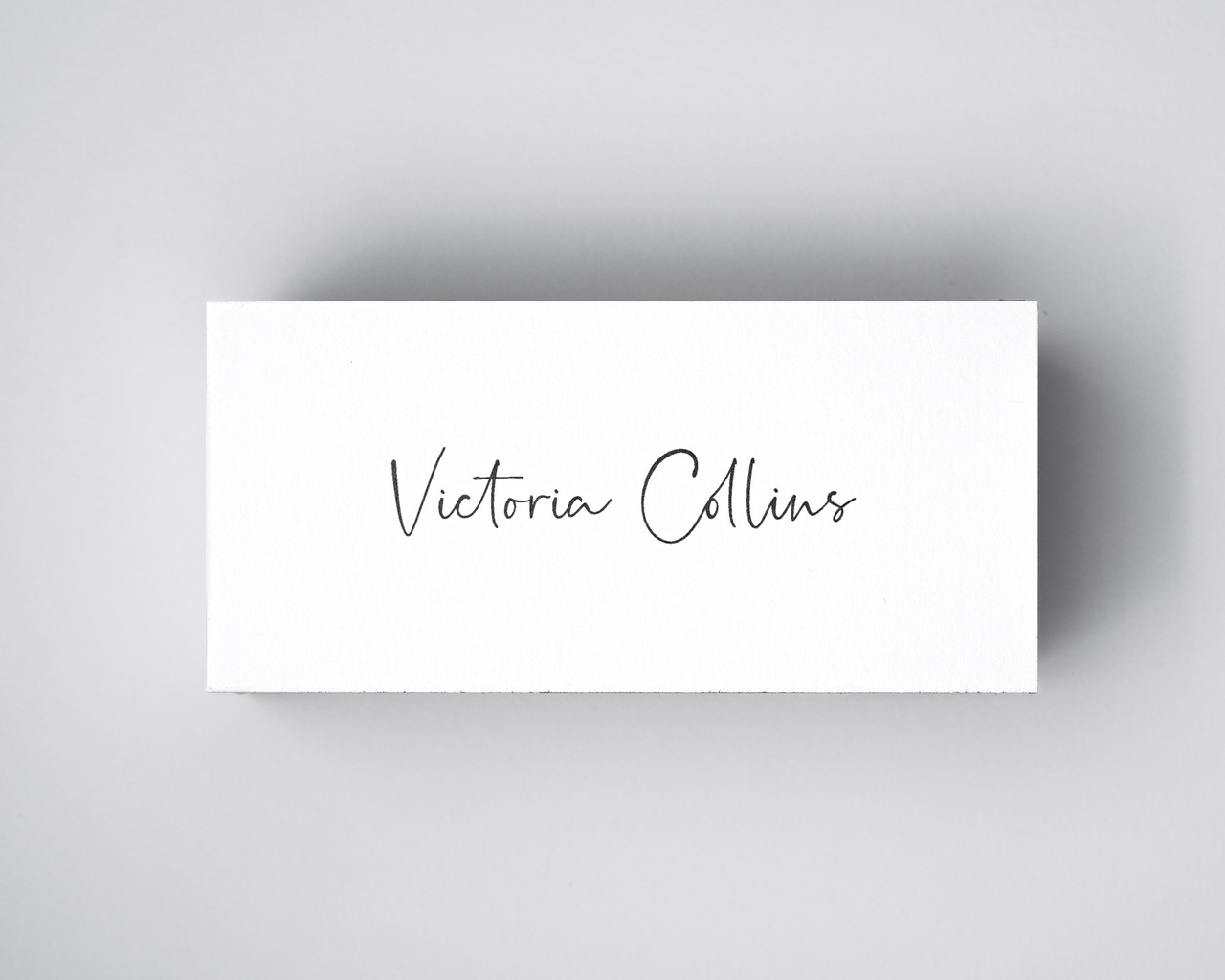 Dove White place card printed with guest name in black ink – elegant and timeless in a smooth white finish.