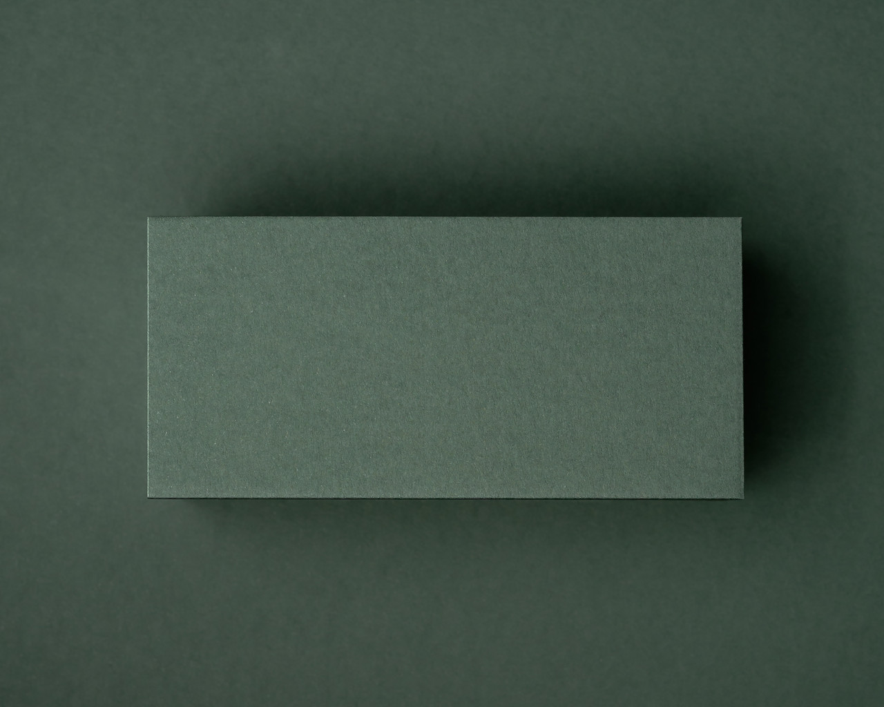 A blank khaki green flat place card displayed on a matching khaki background, highlighting its rich natural tone and thick 300gsm texture.