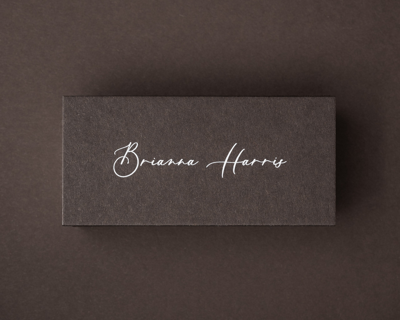 Personalised cocoa brown flat place card with a name printed in elegant white ink.