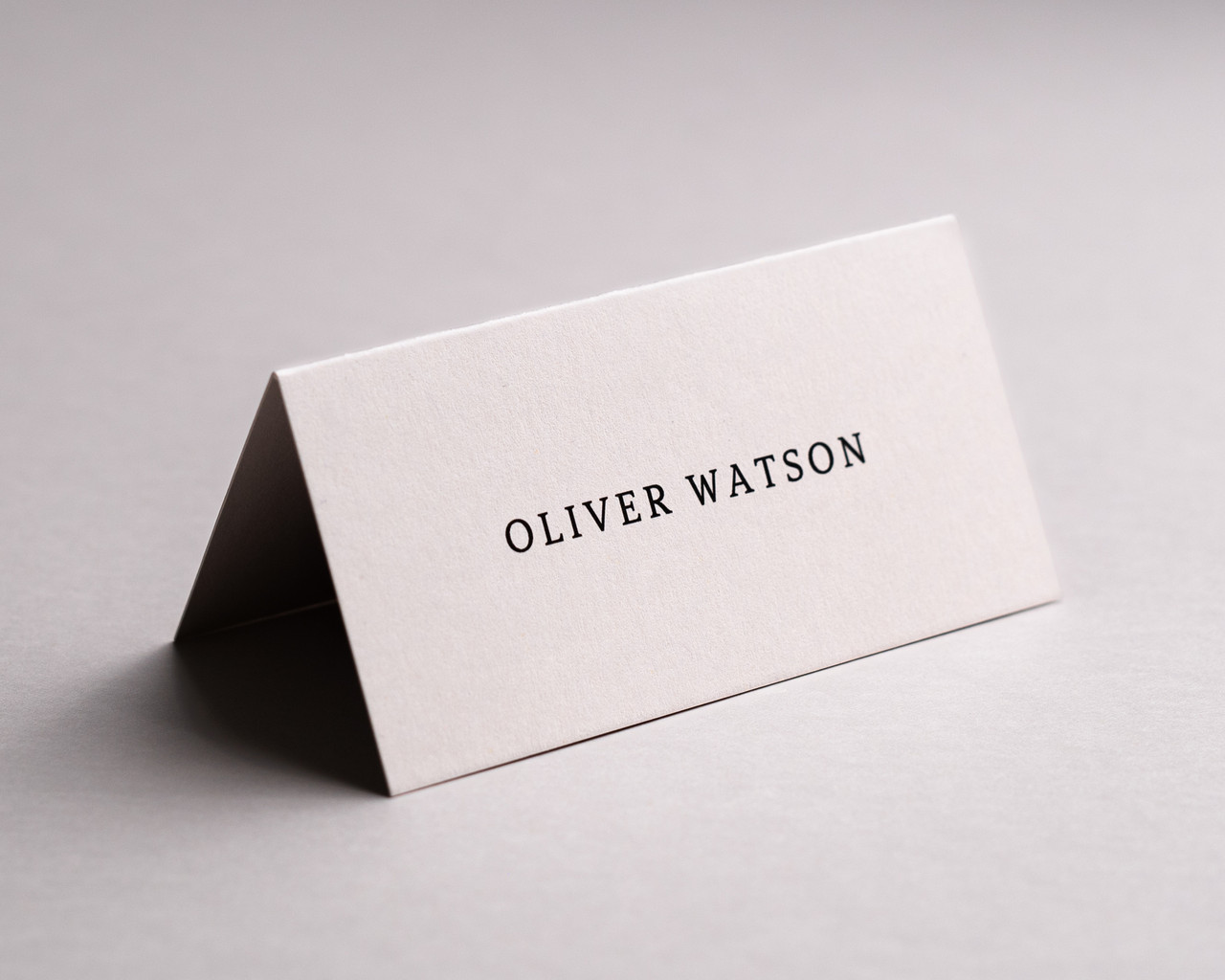 Personalised Almond folded place card with black ink printing, 300gsm card