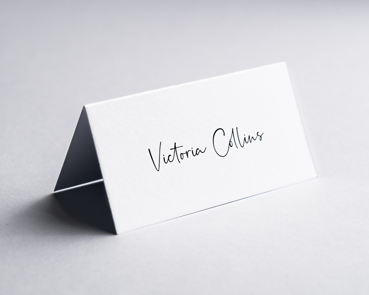 Dove White folded place card with black ink personalised name printing, ideal for weddings and events.