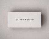 Personalised ivory place card printed in black serif font, centred cleanly on 300gsm almond cardstock.
