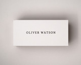 Personalised ivory place card printed in black serif font, centred cleanly on 300gsm almond cardstock.