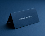 Personalised navy folded place card with white ink printing, 270gsm or 350gsm card, custom name design for weddings or events.