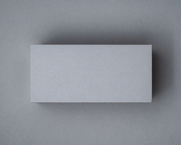 Flat lay of blank mid grey flat place card – premium 270gsm card for weddings and events
