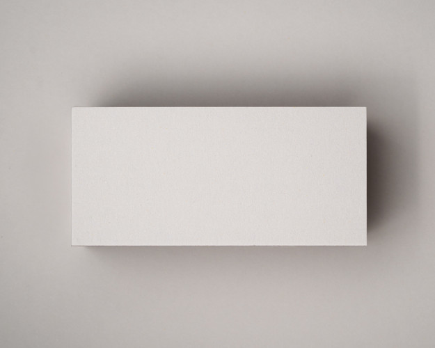 A blank flat ivory (almond) place card photographed on a matching matte background, showcasing its smooth 300gsm texture and warm neutral tone.