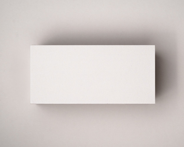 A blank flat ivory (almond) place card photographed on a matching matte background, showcasing its smooth 300gsm texture and warm neutral tone.