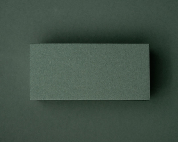 A blank khaki green flat place card displayed on a matching khaki background, highlighting its rich natural tone and thick 300gsm texture.