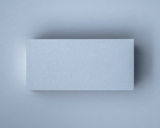 A blank Powder Blue flat place card on a matching blue background, showing the soft pastel tone and clean-cut edge.