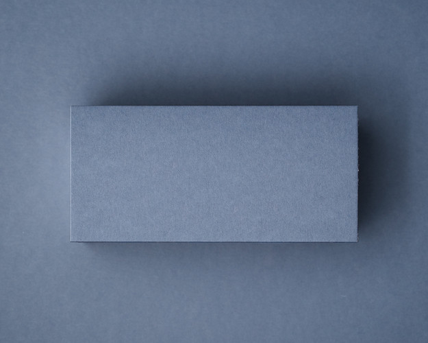 Airforce Blue flat place card in premium 300gsm cardstock, blank and unprinted, photographed on matching background.