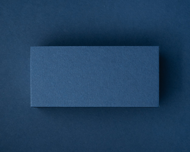 A blank navy blue flat place card made from thick premium cardstock, ideal for custom printing.