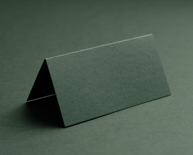 Blank khaki folded place card on textured background, 300gsm card stock