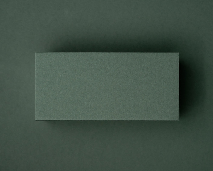 A blank khaki green flat place card displayed on a matching khaki background, highlighting its rich natural tone and thick 300gsm texture.