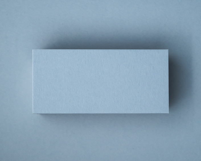 A blank Dusty Blue flat place card displayed on matching cardstock, showcasing the smooth texture and rich colour of the 300gsm paper.