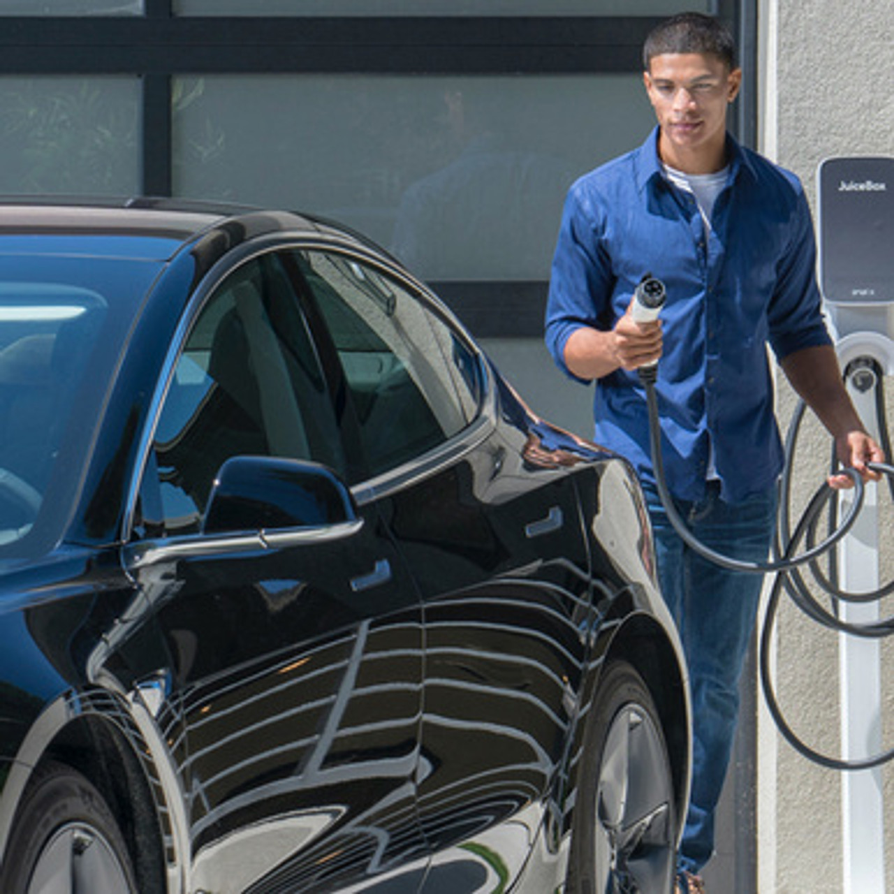 Man charging car with EV Charger JuiceBox 40