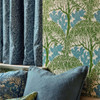 Morris & Co The Savaric Wallpaper 217340 Garden Green close up showing tree canopy design with upholstered seating and curtains