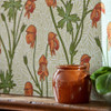 Close-up of Morris & Co Monkshood wallpaper showing orange monkshood flowers and green stems with decorative background