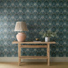 Morris & Co Woodbell & Anemone Wallpaper Indigo used in a living space with wooden console table, ceramic lamp and neutral styling