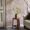 Morris & Co Chamomile Wallpaper Flax Madder close up showing fine linework detail and delicate floral pattern in warm red and neutral tones
