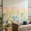 Harlequin Saltillo Grounded Succulent Haze wallpaper styled as a full feature wall behind a patterned sofa in a bright interior.
